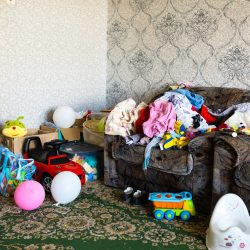 A mess in the room. A lot of things are lying around the apartment. House is in the room A mess in the room. A lot of things are lying around the apartment. House is in the room